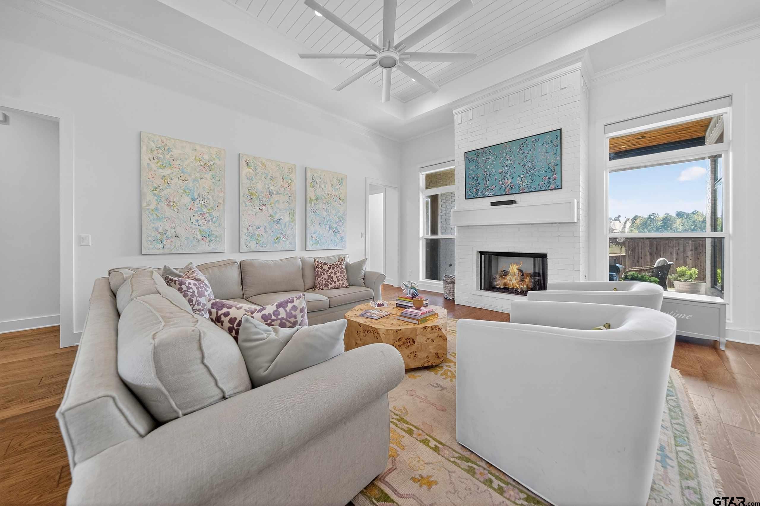 1572 Maple Lane Tyler, TX 75703 - Photo 9 of 47 a living room with furniture a large window and a fireplace