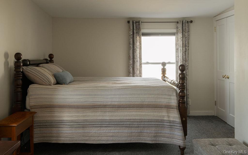 307 Sepasco Lake Road Rhinebeck, NY 12572 - Photo 11 of 24 a bedroom with a bed and a window