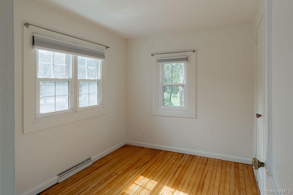 307 Sepasco Lake Road Rhinebeck, NY 12572 - Photo 15 of 24 a view of an empty room with wooden floor and a window