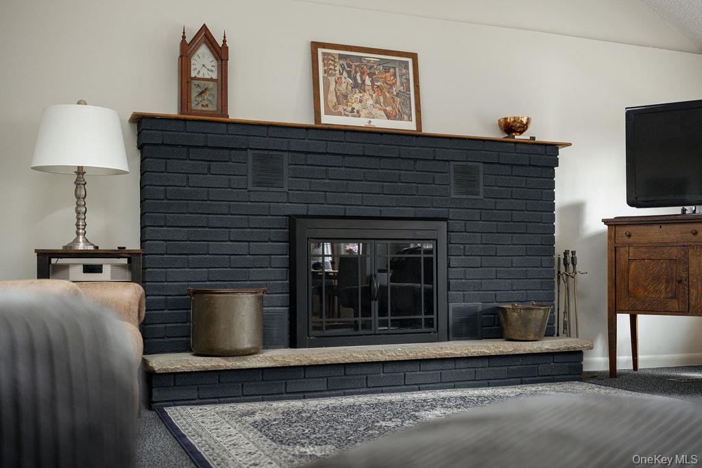307 Sepasco Lake Road Rhinebeck, NY 12572 - Photo 4 of 24 a living room with furniture a flat screen tv and a fireplace