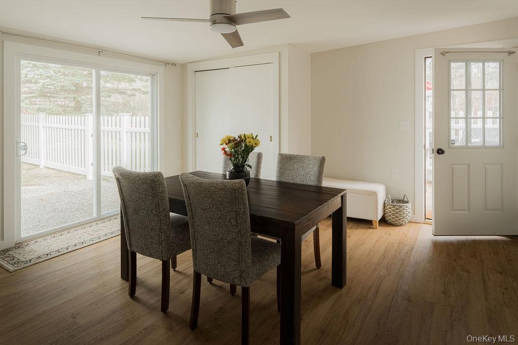 307 Sepasco Lake Road Rhinebeck, NY 12572 - Photo 7 of 24 a view of a dining room with furniture and wooden floor