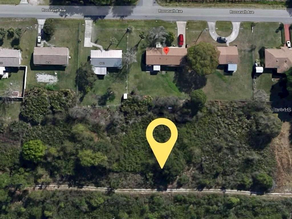 an aerial view of a house with a backyard