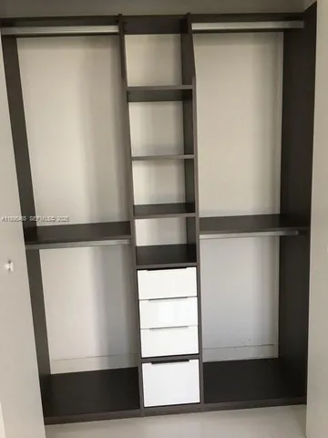 a kitchen with a sink a table and chairs