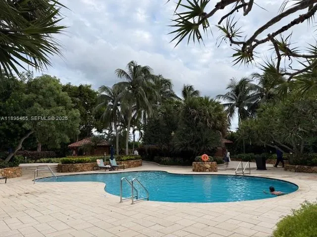 a view of a patio with table and chairs and potted plants with large tree