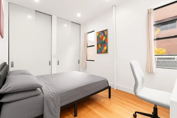 a bedroom with a bed and a chair