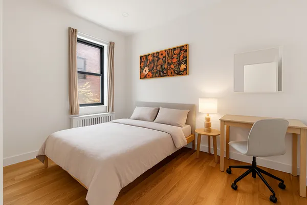 a bedroom with a bed and a chair