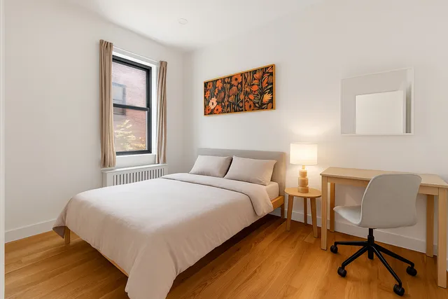 a bedroom with a bed and a chair