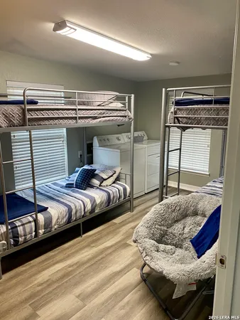 a bedroom with bed and wooden floor