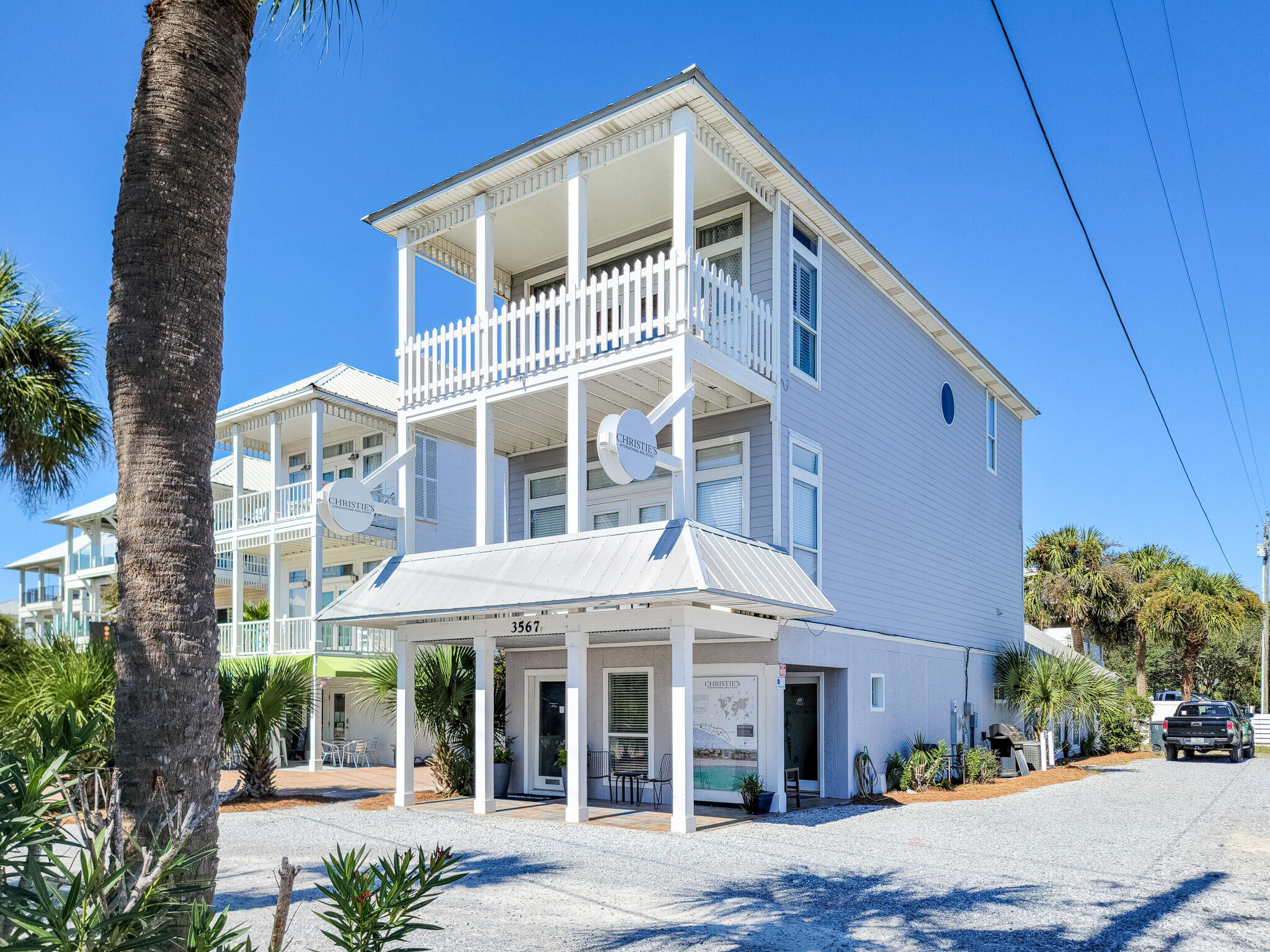 3567 East County Highway 30A Santa Rosa Beach, FL 32459 - Photo 1 of 31 a front view of a building with a garden and plants