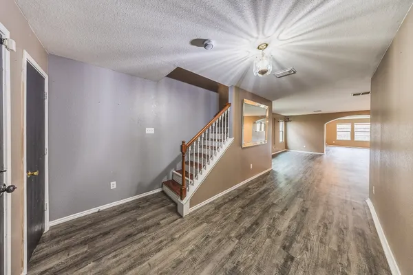 a view of entryway and hall with wooden floor