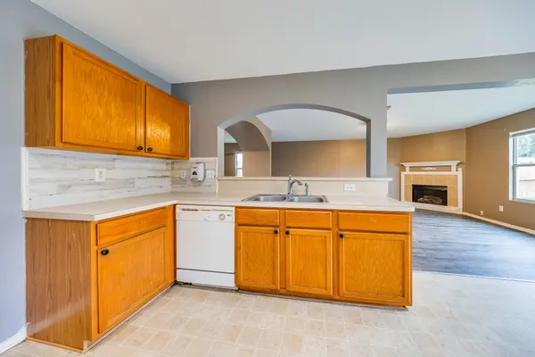 a spacious bathroom with stainless steel appliances granite countertop a sink and a cabinets