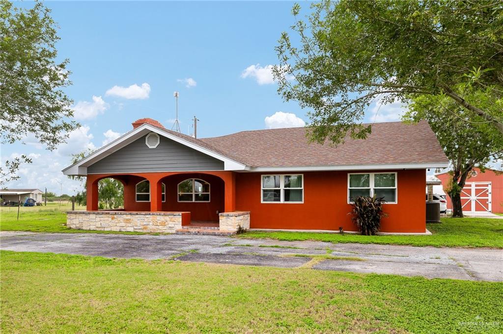 22172 North Olmito Road Rio Hondo, TX 78583 - Photo 5 of 33 a front view of a house with a yard