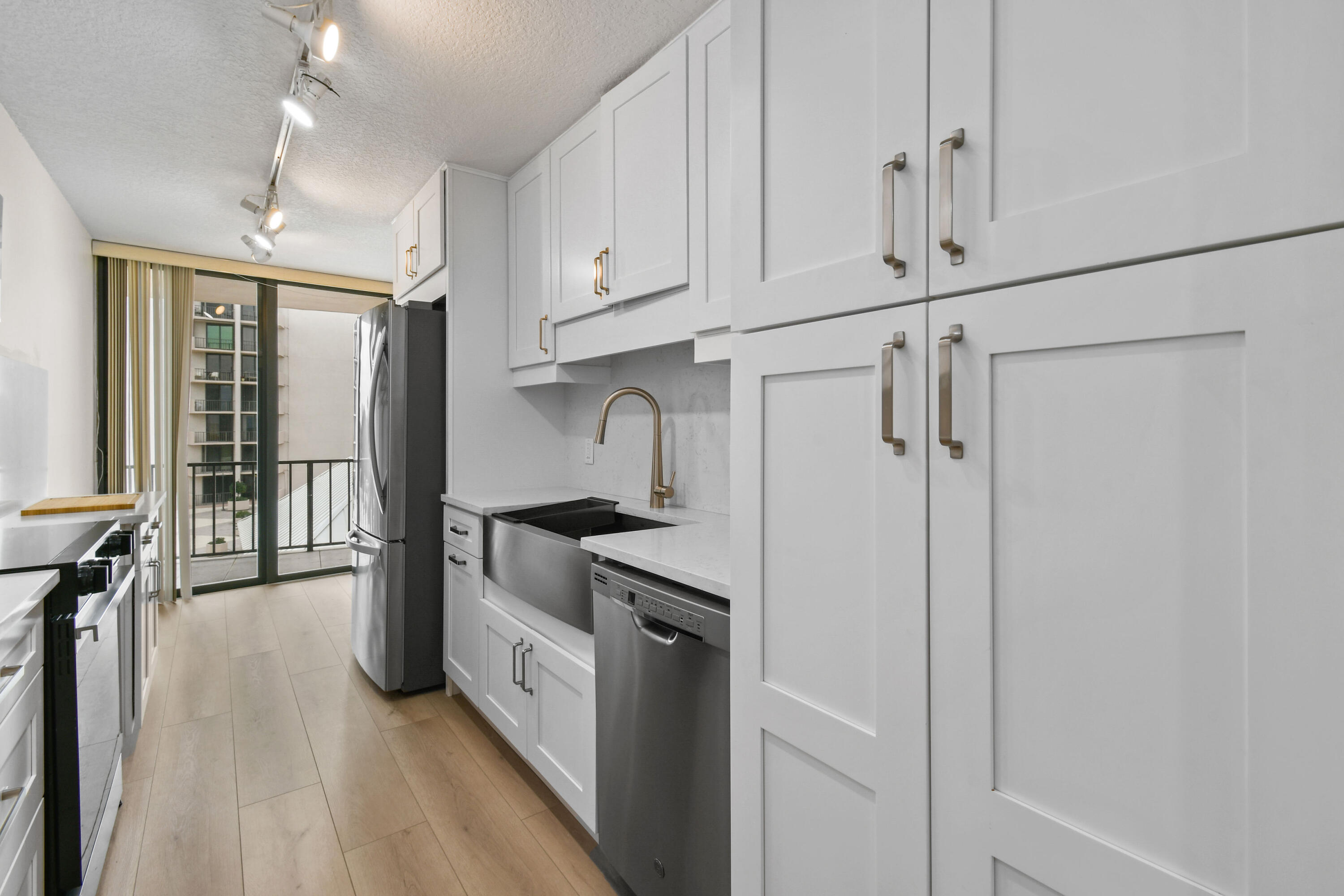 4200 North Ocean Drive, Unit 1 Riviera Beach, FL 33404 - Photo 30 of 59 a kitchen with stainless steel appliances a refrigerator and a stove