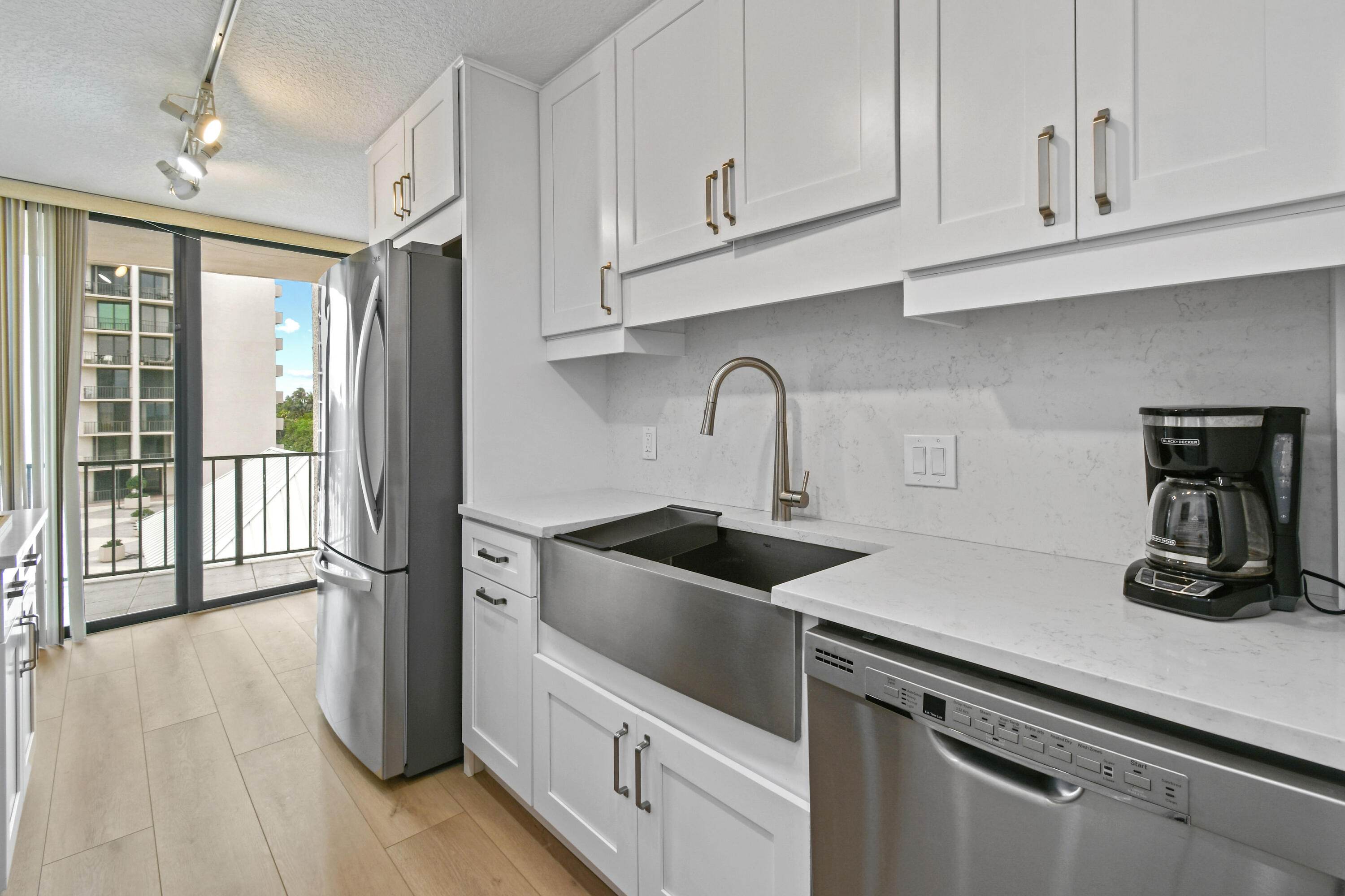 4200 North Ocean Drive, Unit 1 Riviera Beach, FL 33404 - Photo 32 of 59 a kitchen with white cabinets and a sink