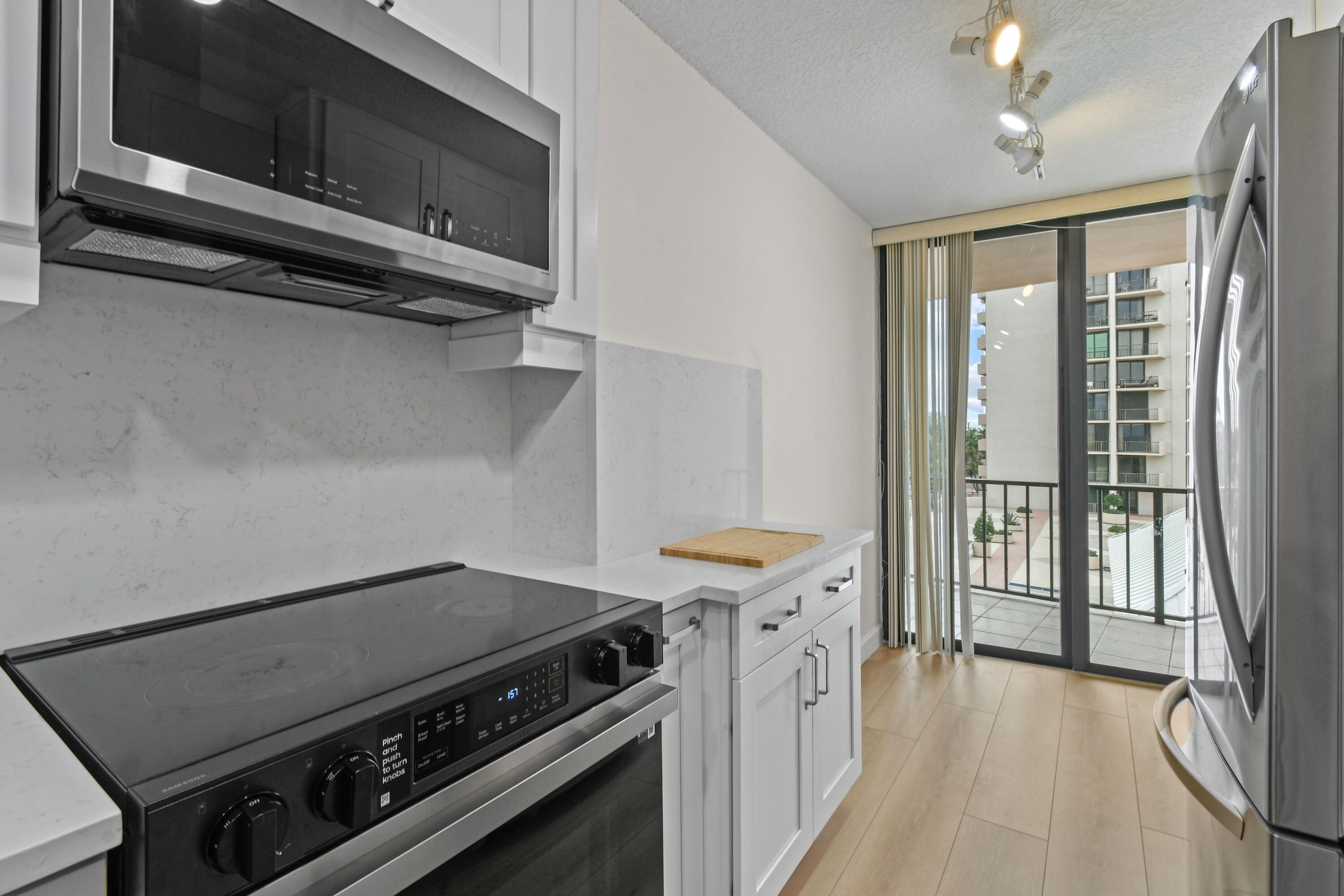 4200 North Ocean Drive, Unit 1 Riviera Beach, FL 33404 - Photo 33 of 59 a kitchen with a stove and a microwave