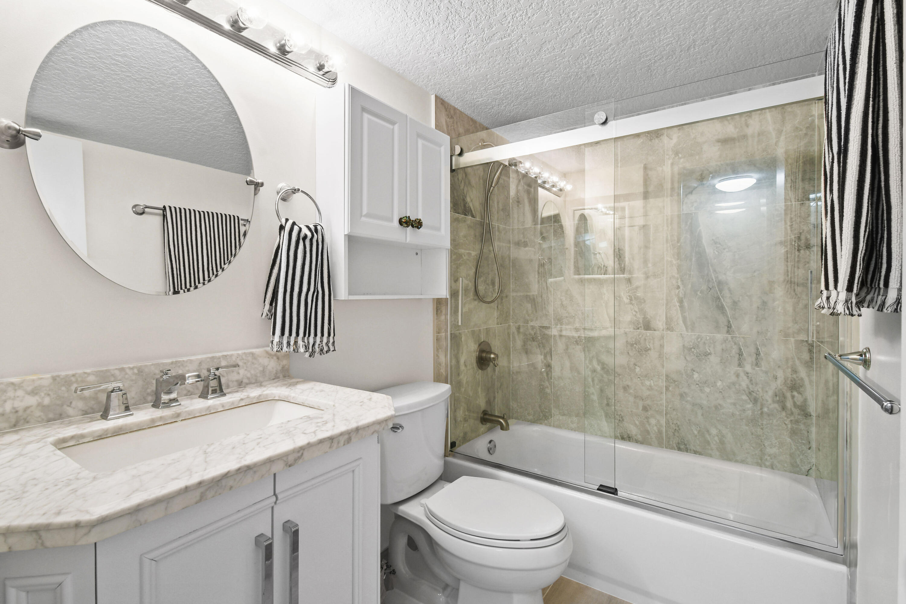 4200 North Ocean Drive, Unit 1 Riviera Beach, FL 33404 - Photo 39 of 59 a bathroom with a sink a toilet and shower