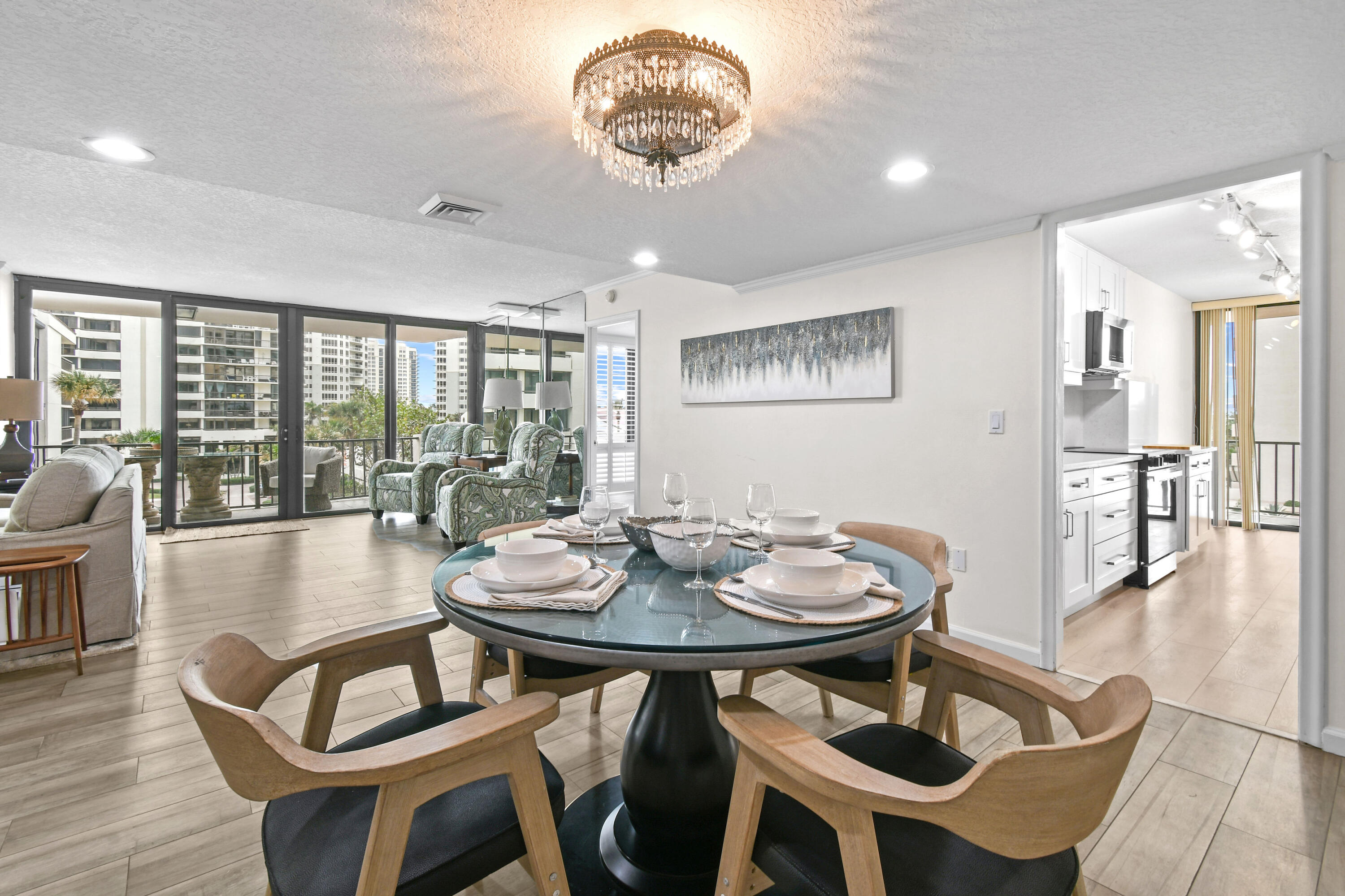 4200 North Ocean Drive, Unit 1 Riviera Beach, FL 33404 - Photo 41 of 59 a view of a dining room with furniture wooden floor and chandelier