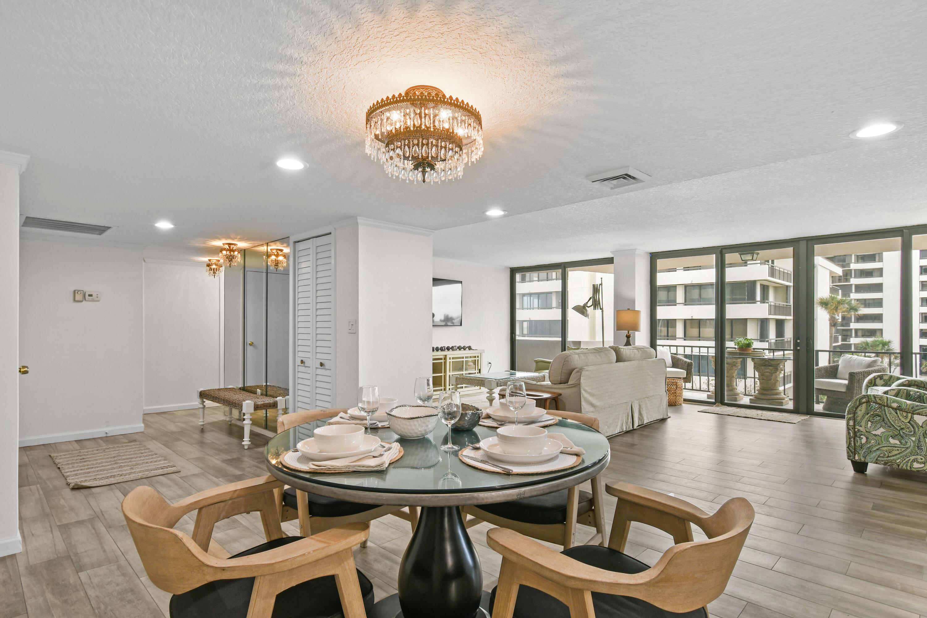 4200 North Ocean Drive, Unit 1 Riviera Beach, FL 33404 - Photo 44 of 59 a view of a dining room with furniture wooden floor and chandelier