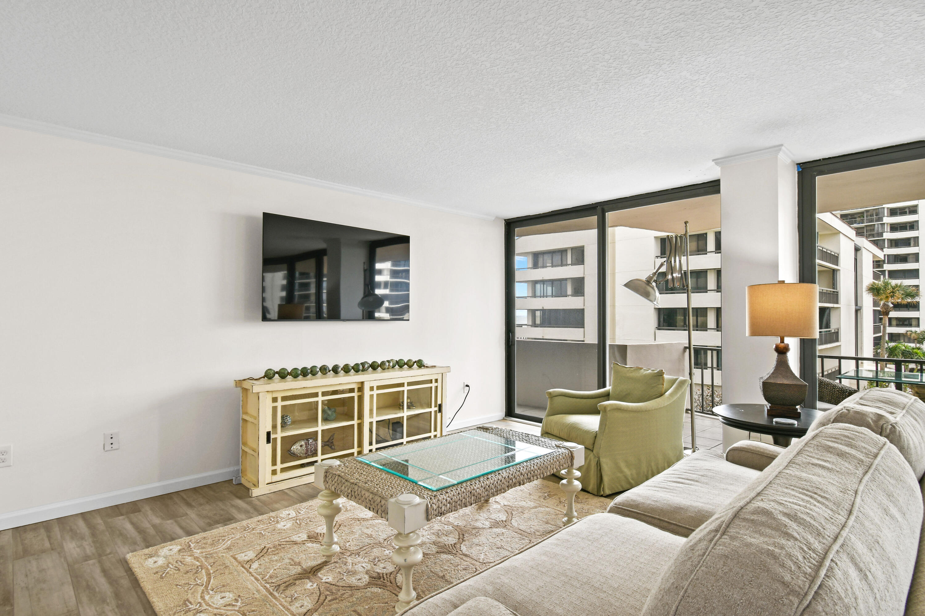 4200 North Ocean Drive, Unit 1 Riviera Beach, FL 33404 - Photo 45 of 59 a living room with furniture windows and a flat screen tv