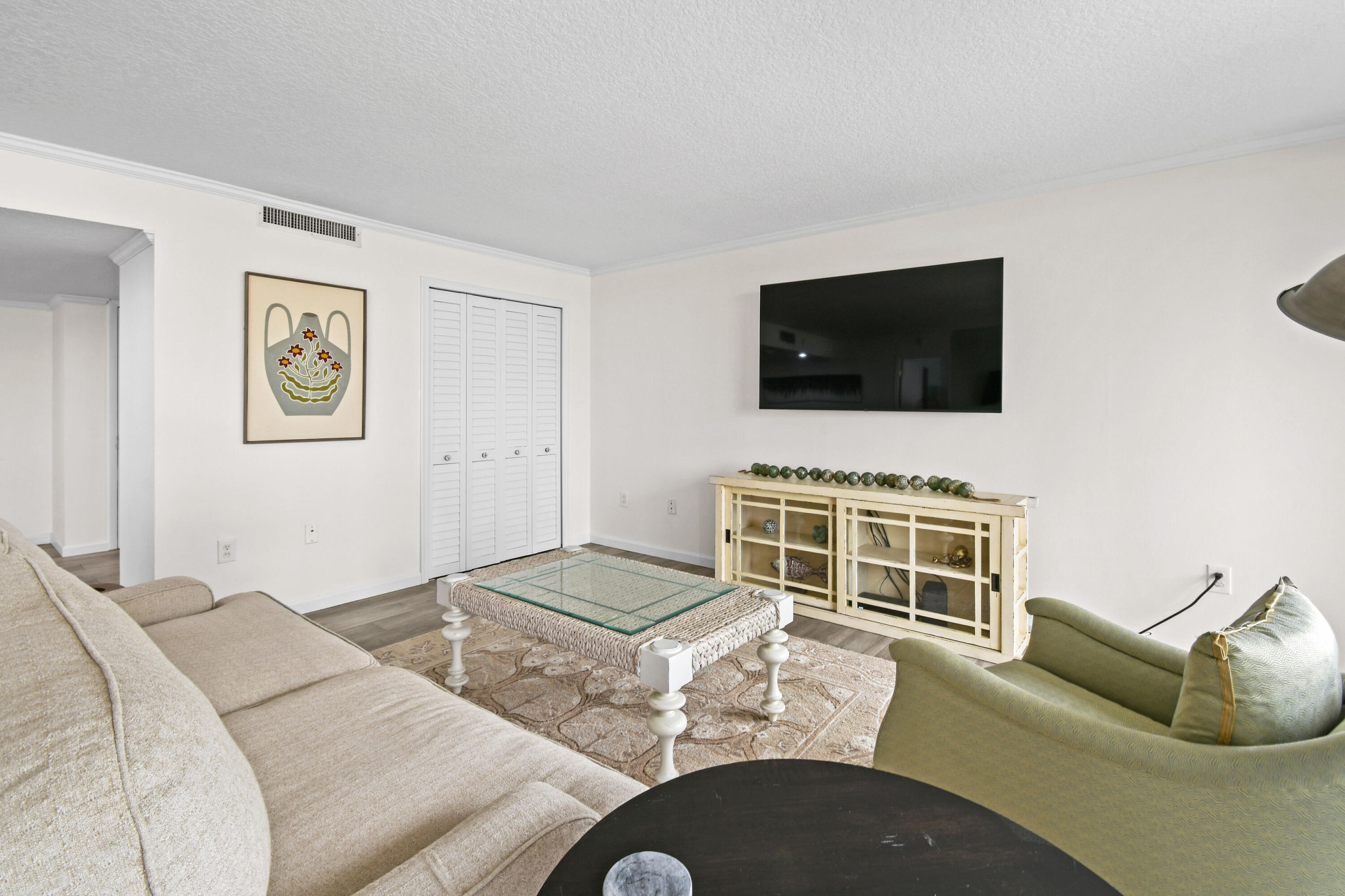 4200 North Ocean Drive, Unit 1 Riviera Beach, FL 33404 - Photo 46 of 59 a living room with furniture and a flat screen tv