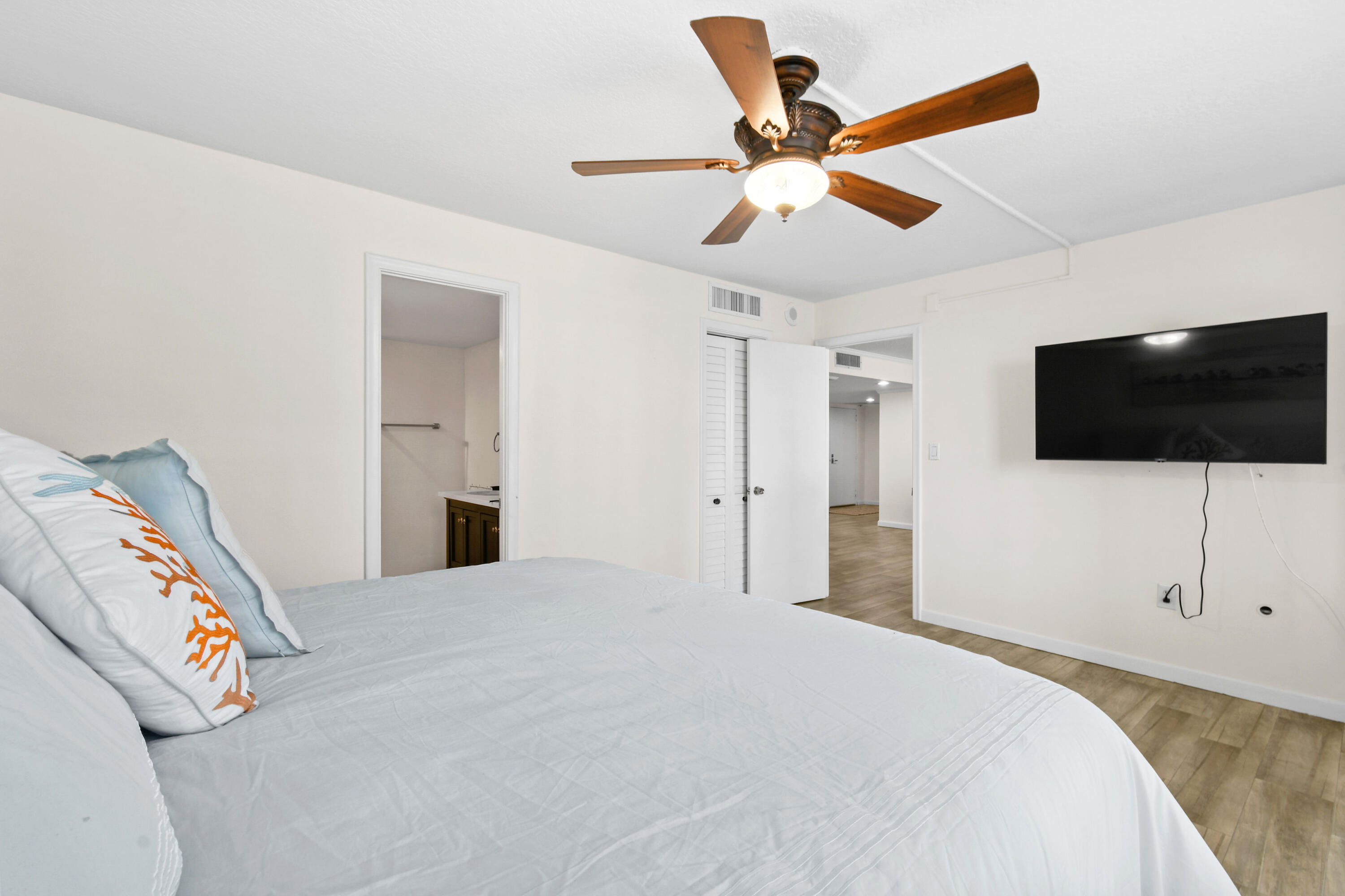 4200 North Ocean Drive, Unit 1 Riviera Beach, FL 33404 - Photo 53 of 59 a bedroom with a bed and a flat screen tv