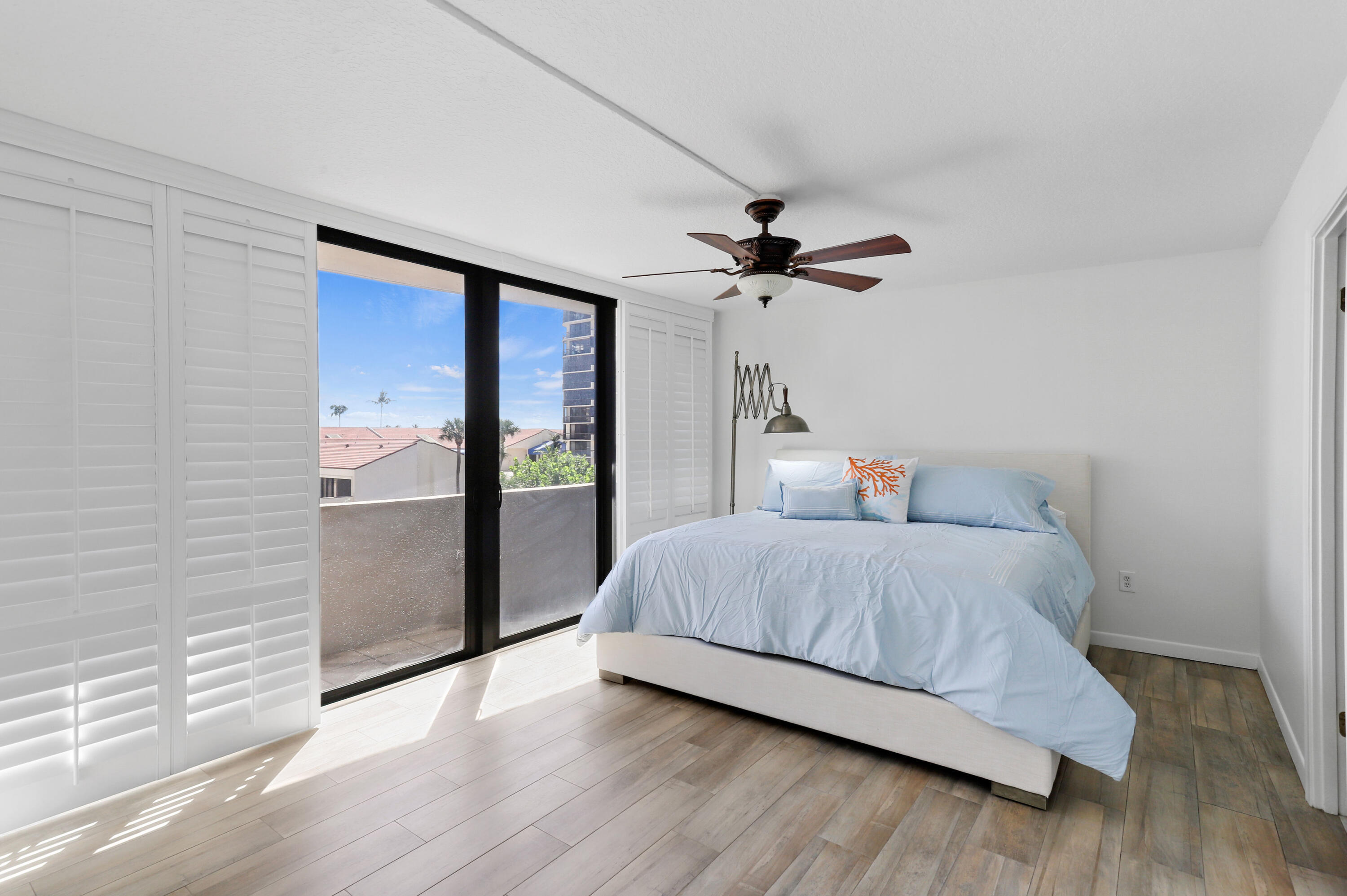 4200 North Ocean Drive, Unit 1 Riviera Beach, FL 33404 - Photo 8 of 59 a bedroom with a bed and a ceiling fan