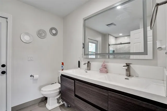 a bathroom with a sink a toilet and mirror
