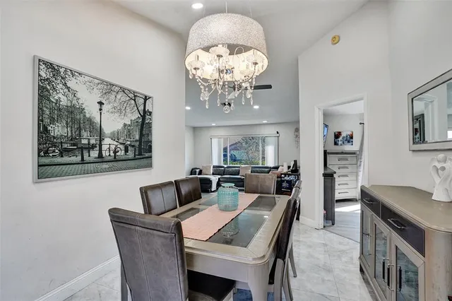 a view of a dining room with furniture and chandelier