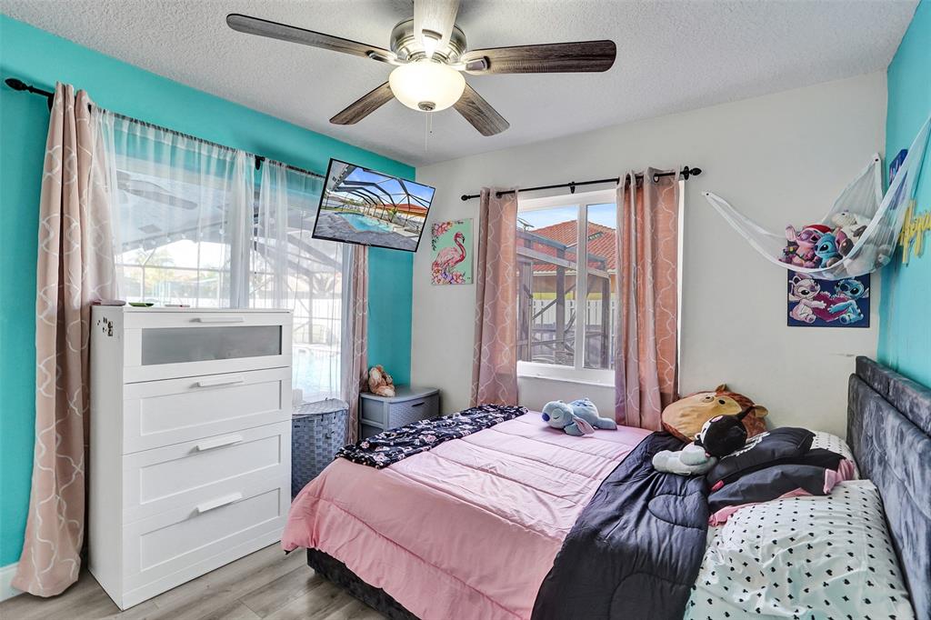 7909 Northwest 19th Street Margate, FL 33063 - Photo 26 of 33 a bedroom with a bed dresser and a window
