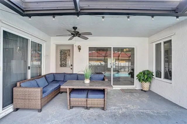 a living room with furniture and a potted plant