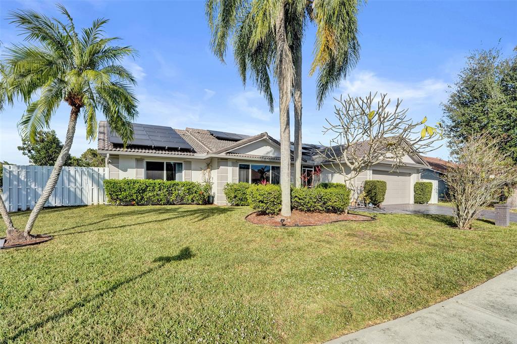 7909 Northwest 19th Street Margate, FL 33063 - Photo 33 of 33 a front view of a house with a yard garage and outdoor seating