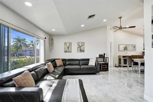 a living room with furniture and a large window