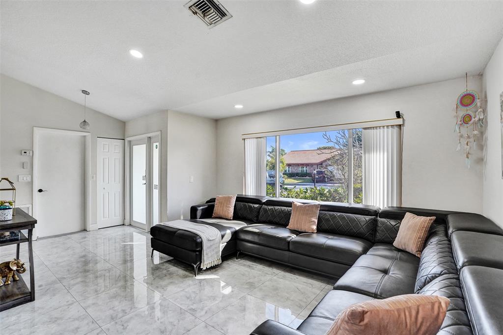 7909 Northwest 19th Street Margate, FL 33063 - Photo 5 of 33 a living room with furniture and a large window