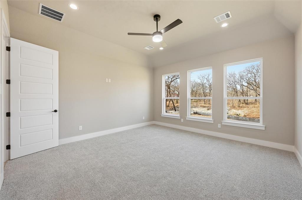1053 Llano Way Poolville, TX 76487 - Photo 27 of 40 an empty room with windows and fan