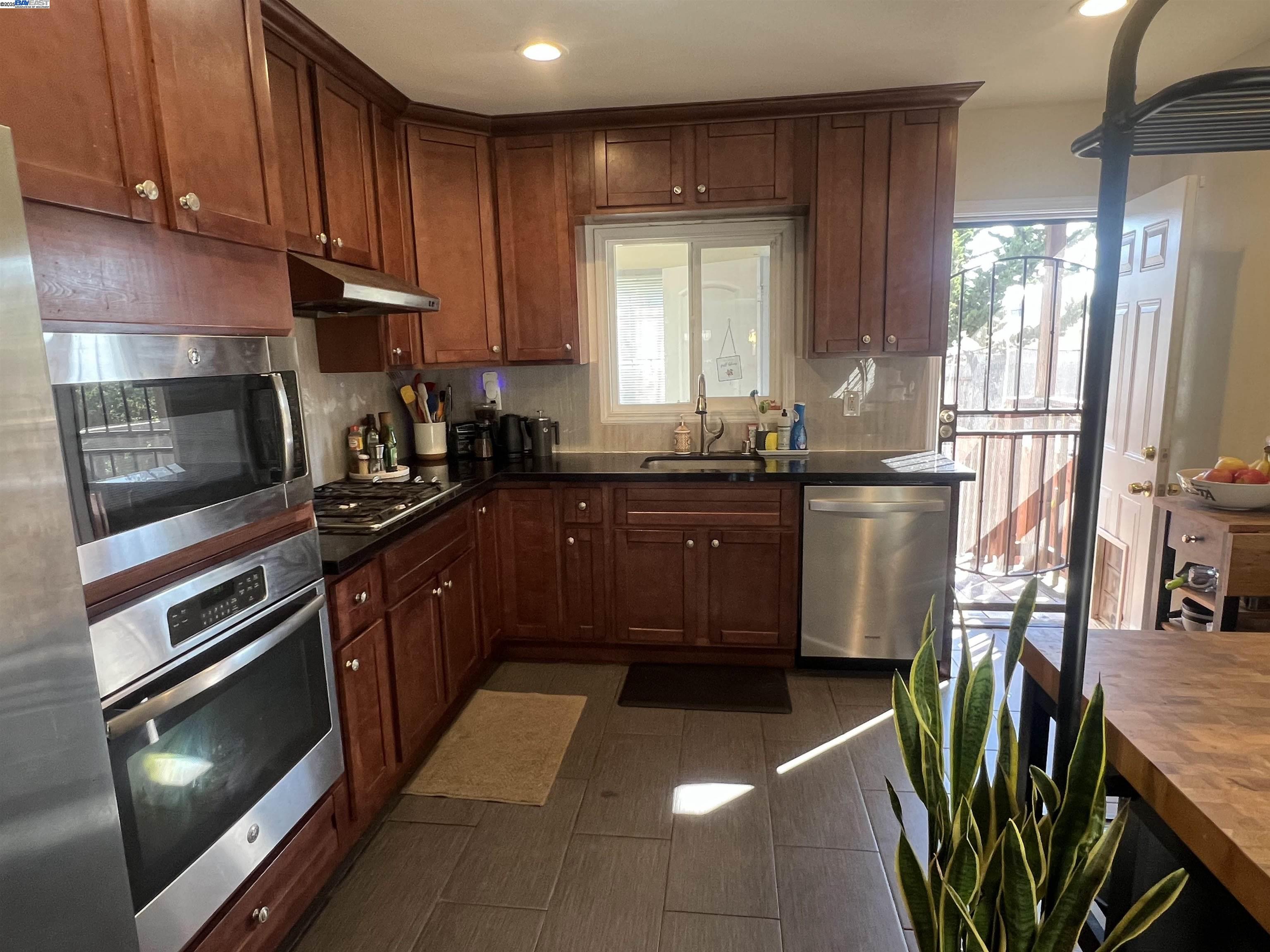 3229 MacArthur Boulevard Oakland, CA 94602 - Photo 2 of 9 a kitchen with stainless steel appliances granite countertop a stove a sink dishwasher and a refrigerator