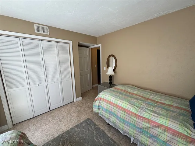 a bedroom with a bed and a mirror