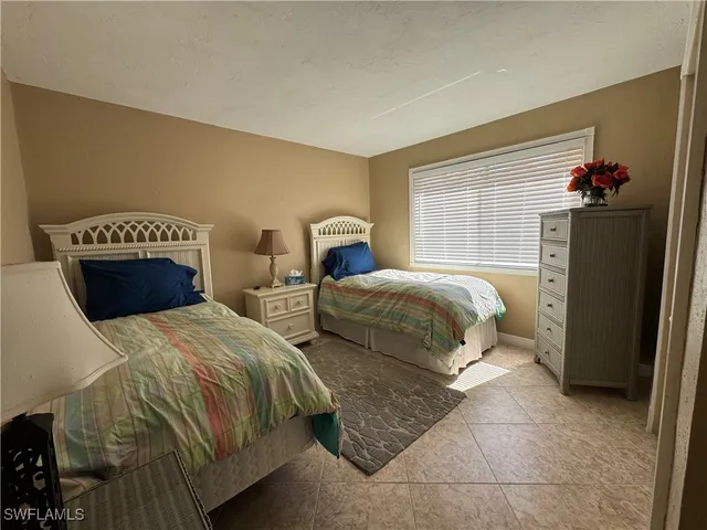 a bedroom with two beds and a dresser