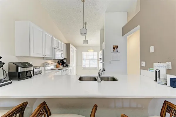 a kitchen with stainless steel appliances a refrigerator sink and cabinets