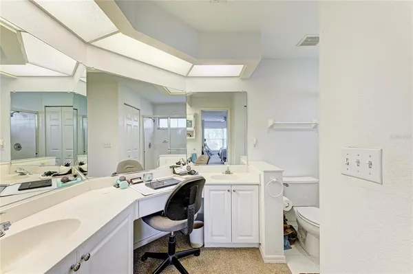 a bedroom with a bed and a ceiling fan