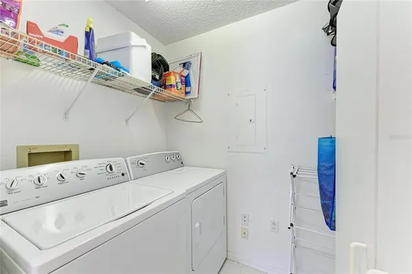 an aerial view of a city with lots of residential buildings ocean and mountain view in back