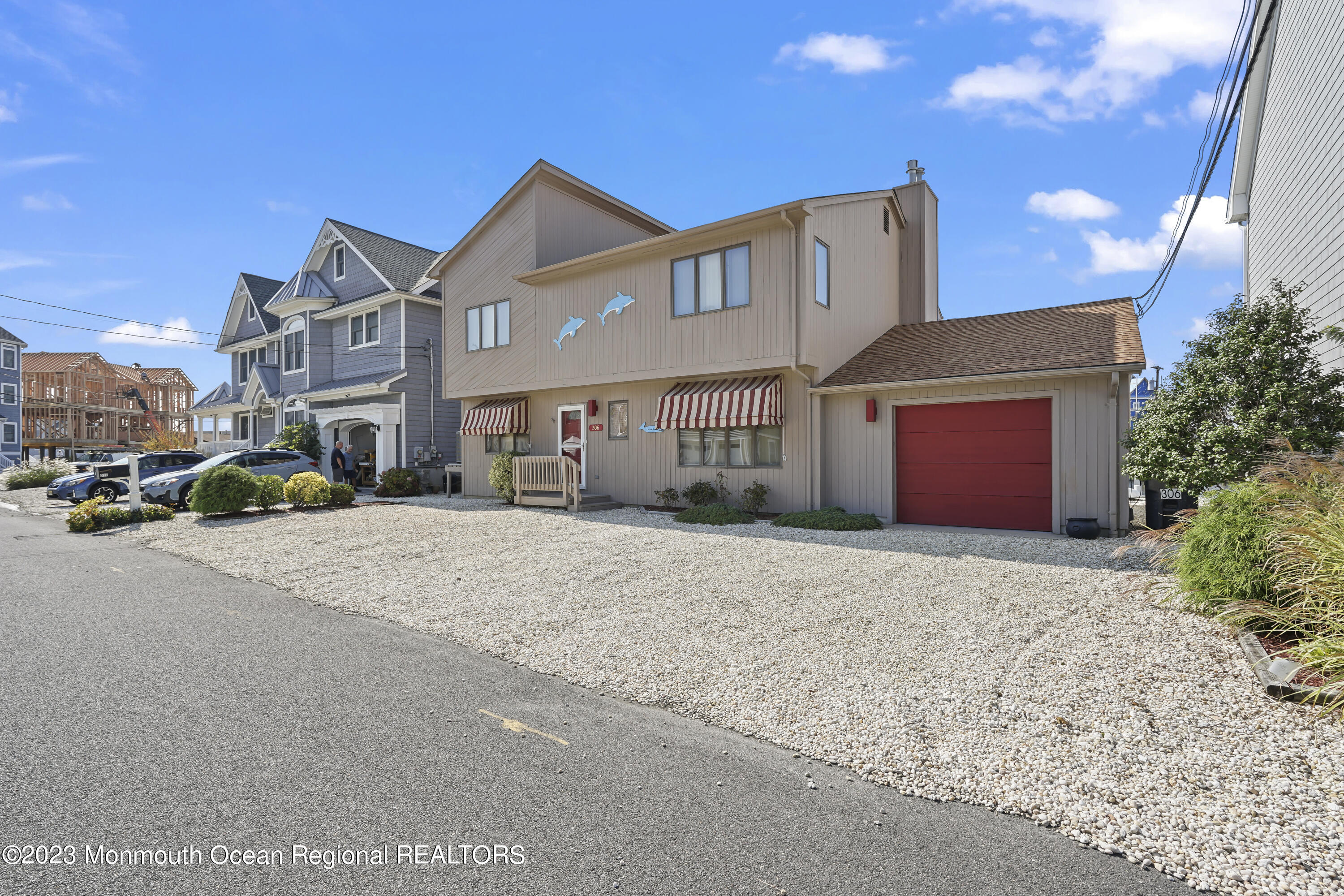 306 Ormond Drive Lavallette, NJ 08735 - Photo 13 of 49 a front view of a house with a yard and garage