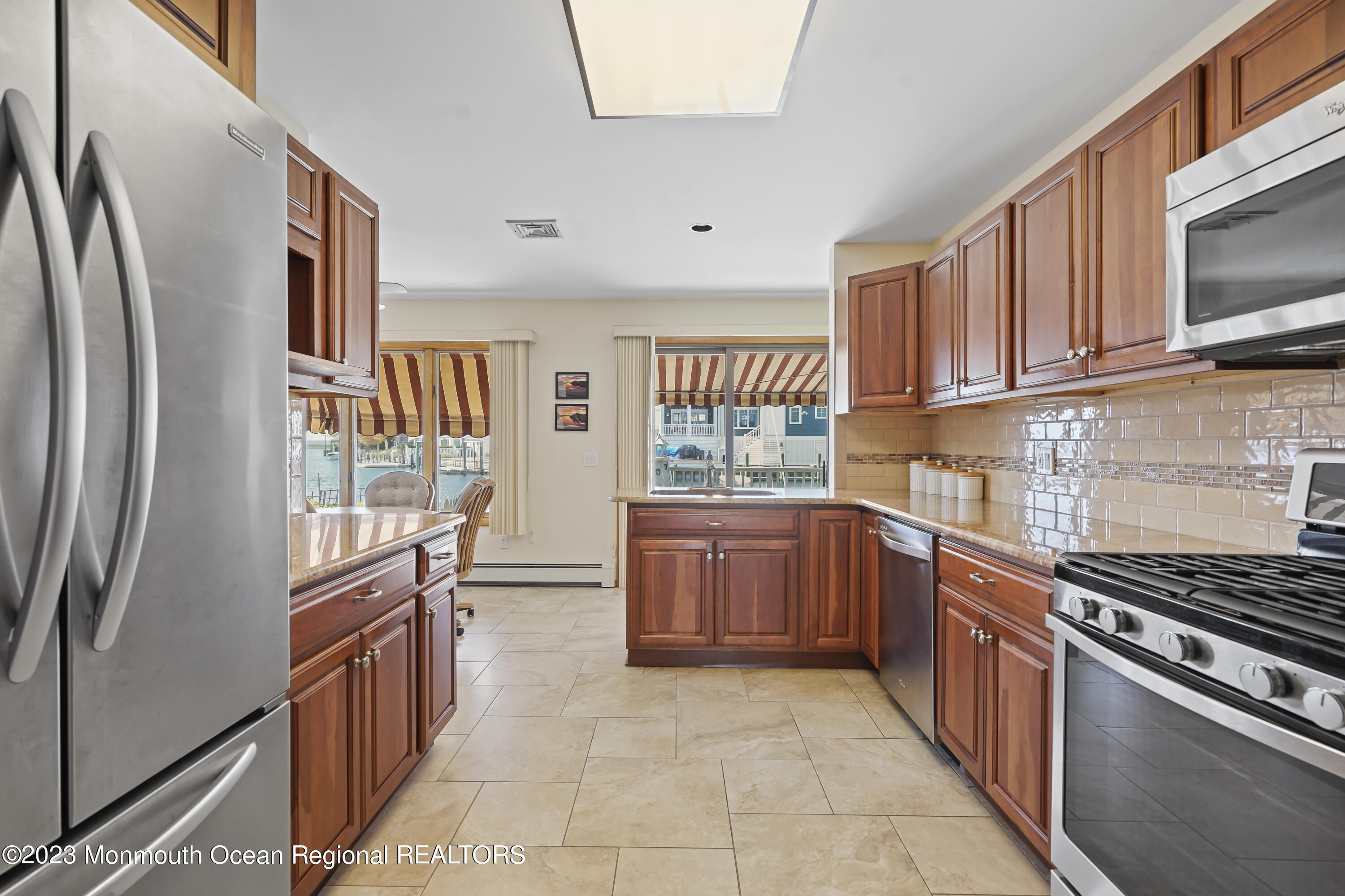 306 Ormond Drive Lavallette, NJ 08735 - Photo 33 of 49 a kitchen with stainless steel appliances granite countertop a refrigerator and a stove top oven