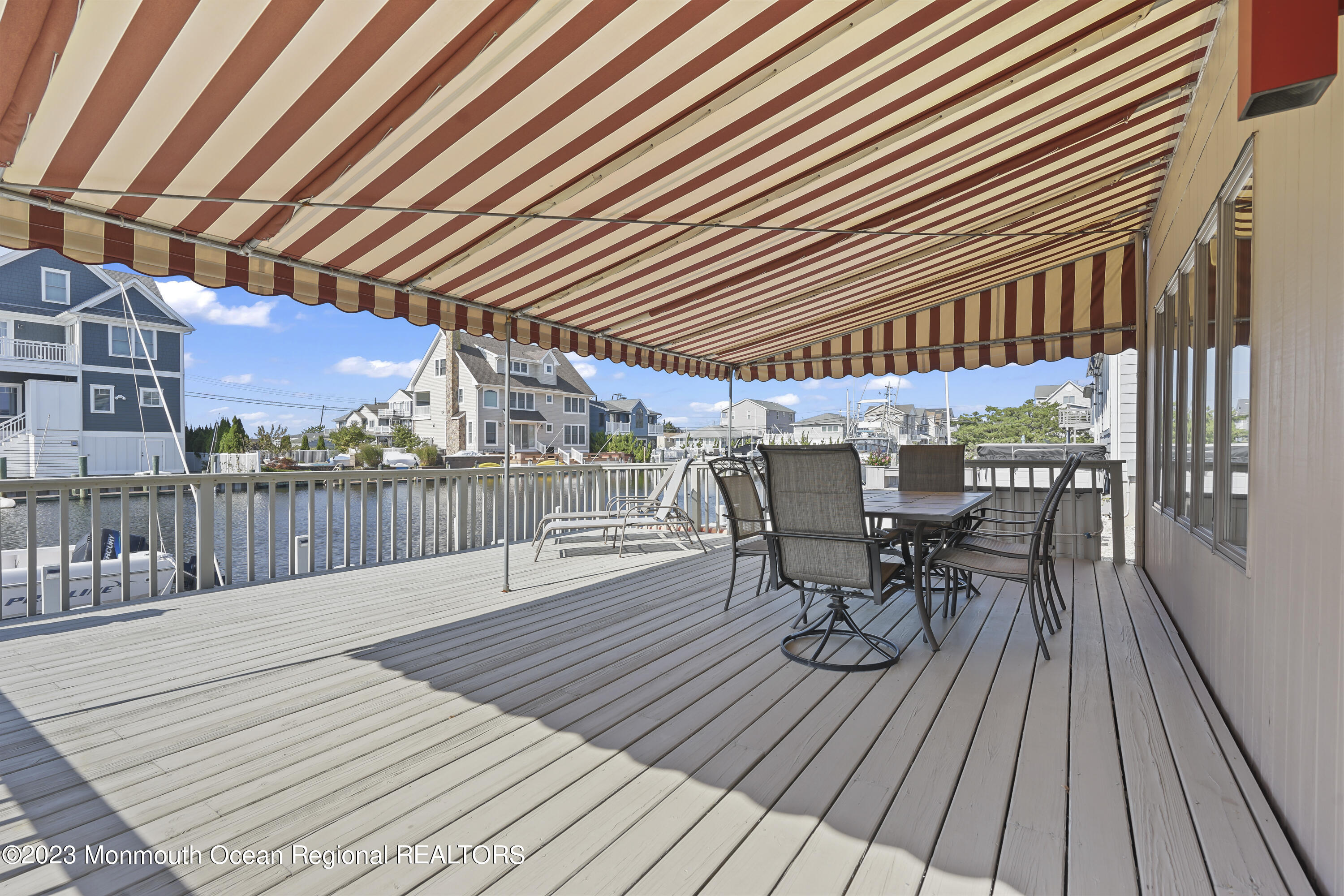 306 Ormond Drive Lavallette, NJ 08735 - Photo 40 of 49 a view of a patio with table and chairs with wooden floor