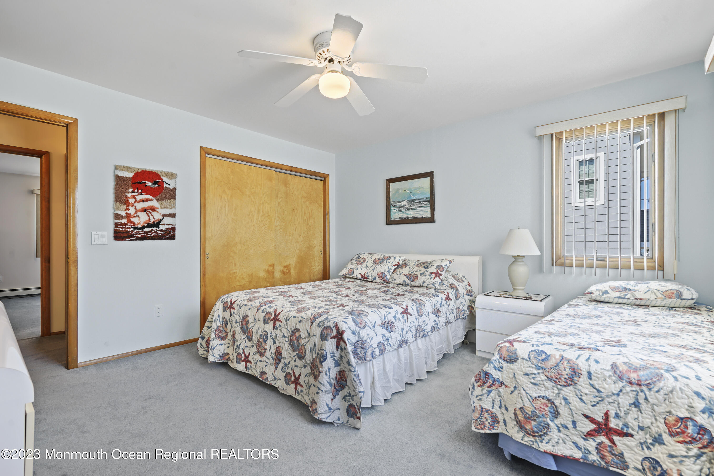 306 Ormond Drive Lavallette, NJ 08735 - Photo 6 of 49 a bedroom with a bed and a chandelier