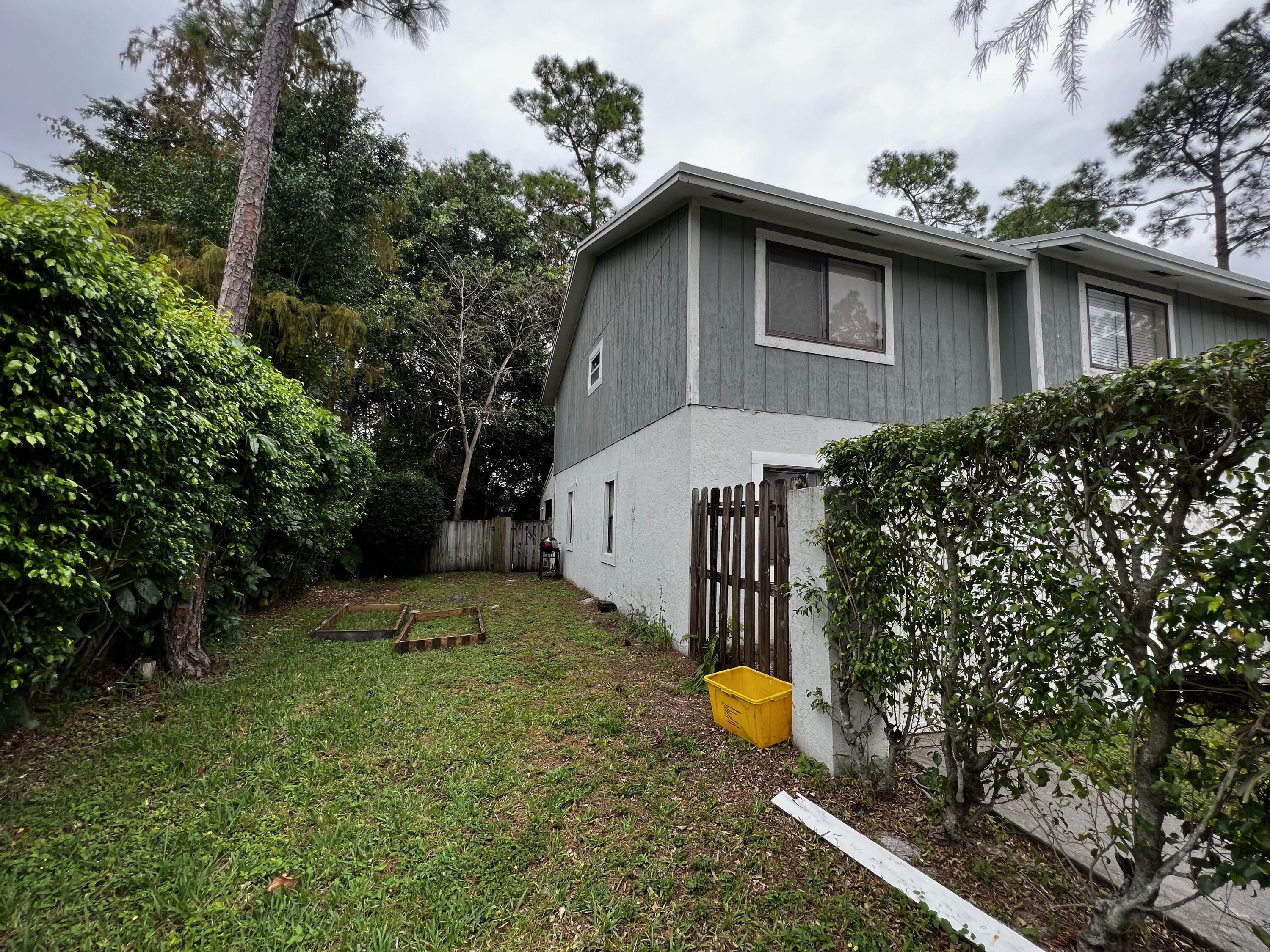 1147 Goldenrod Road Wellington, FL 33414 - Photo 18 of 18 a view of a backyard with plants and a tree