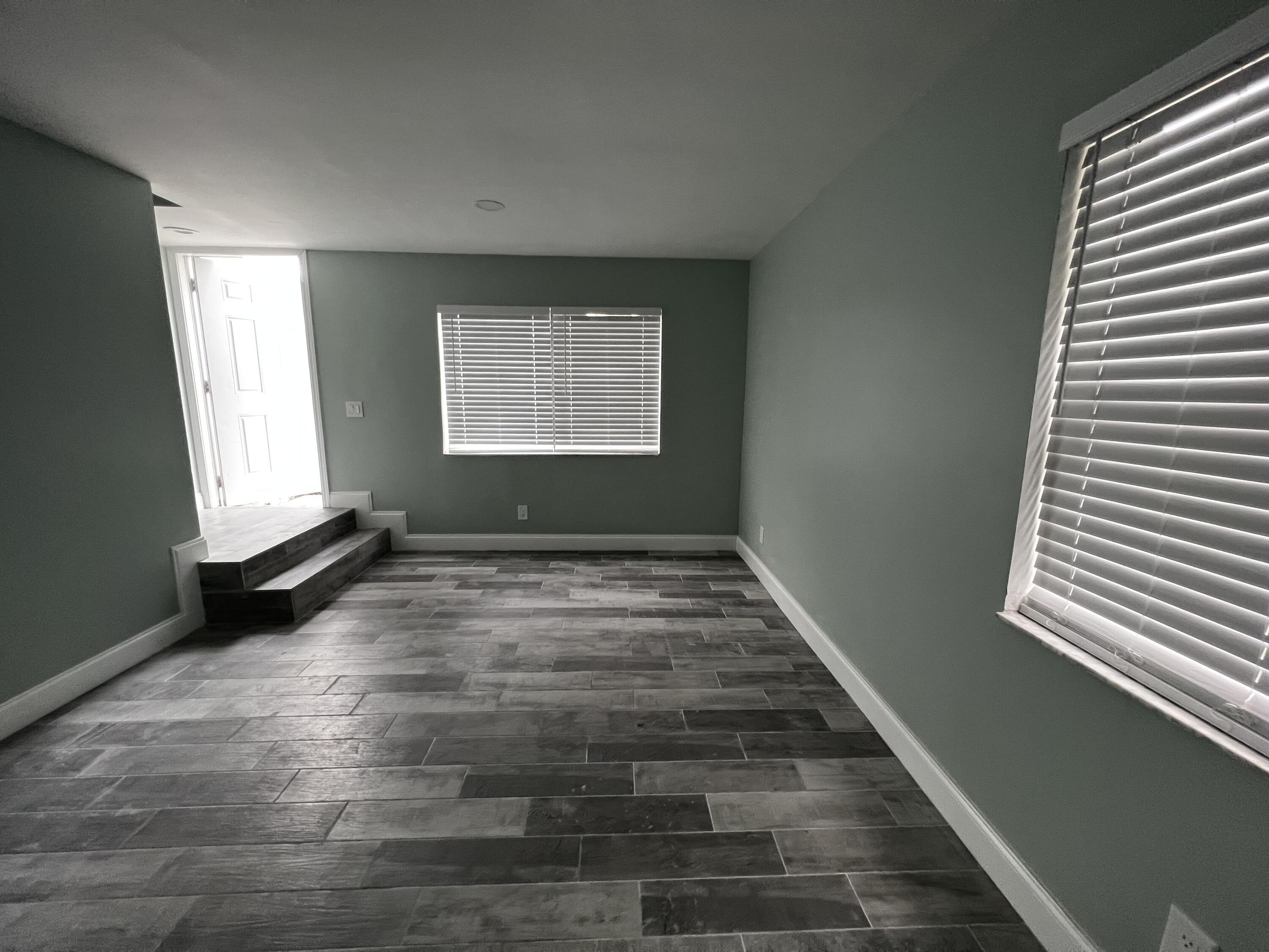 1147 Goldenrod Road Wellington, FL 33414 - Photo 3 of 18 an empty room with windows