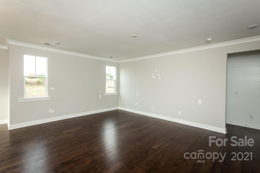 190 Goldenrod Circle Salisbury, NC 28147 - Photo 14 of 16 an empty room with wooden floor and windows