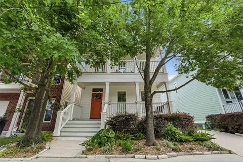 a front view of a house with a garden and plants
