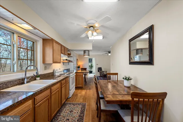 a kitchen with sink refrigerator and cabinets