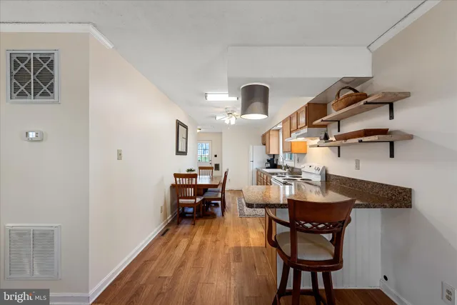 a kitchen with a dining table chairs and white cabinets